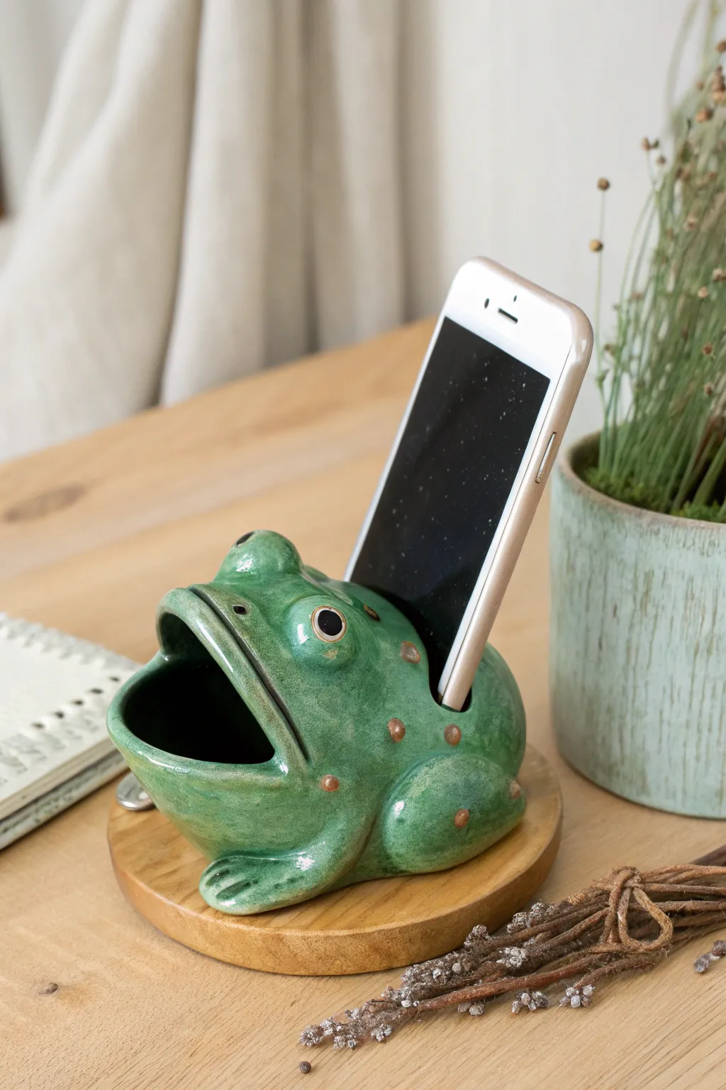Playful glazed frog dock that boosts sound naturally with a wide mouth horn and simple phone slot