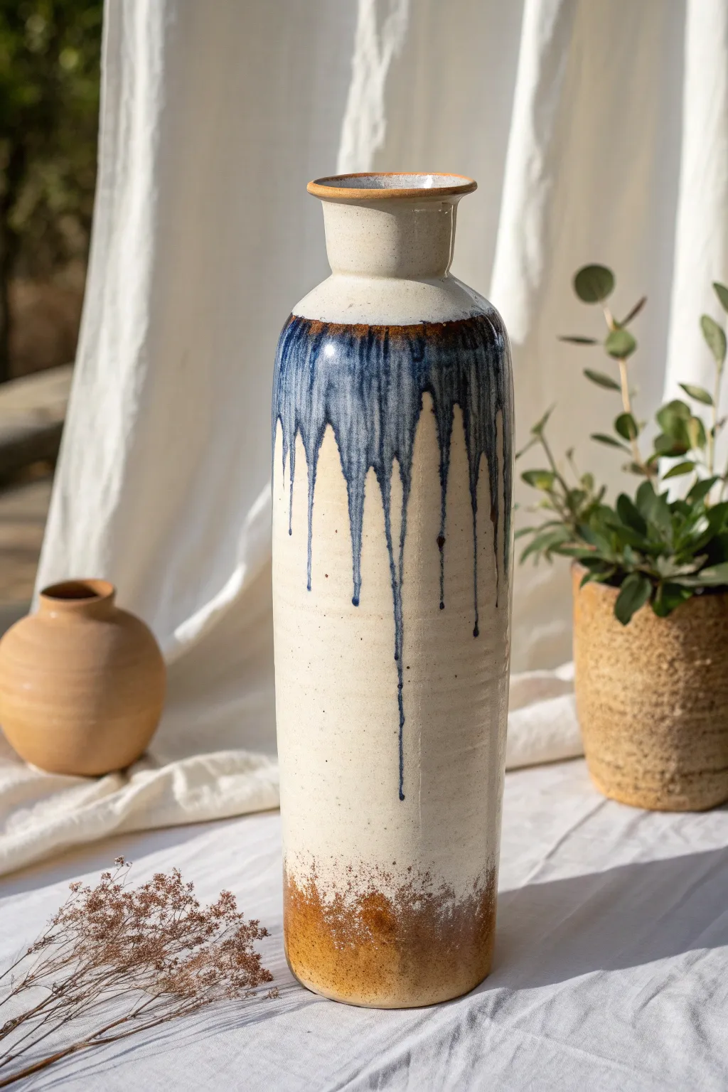 Drippy glaze statement vessel: a simple tall form with bold glaze flow for modern boho decor.