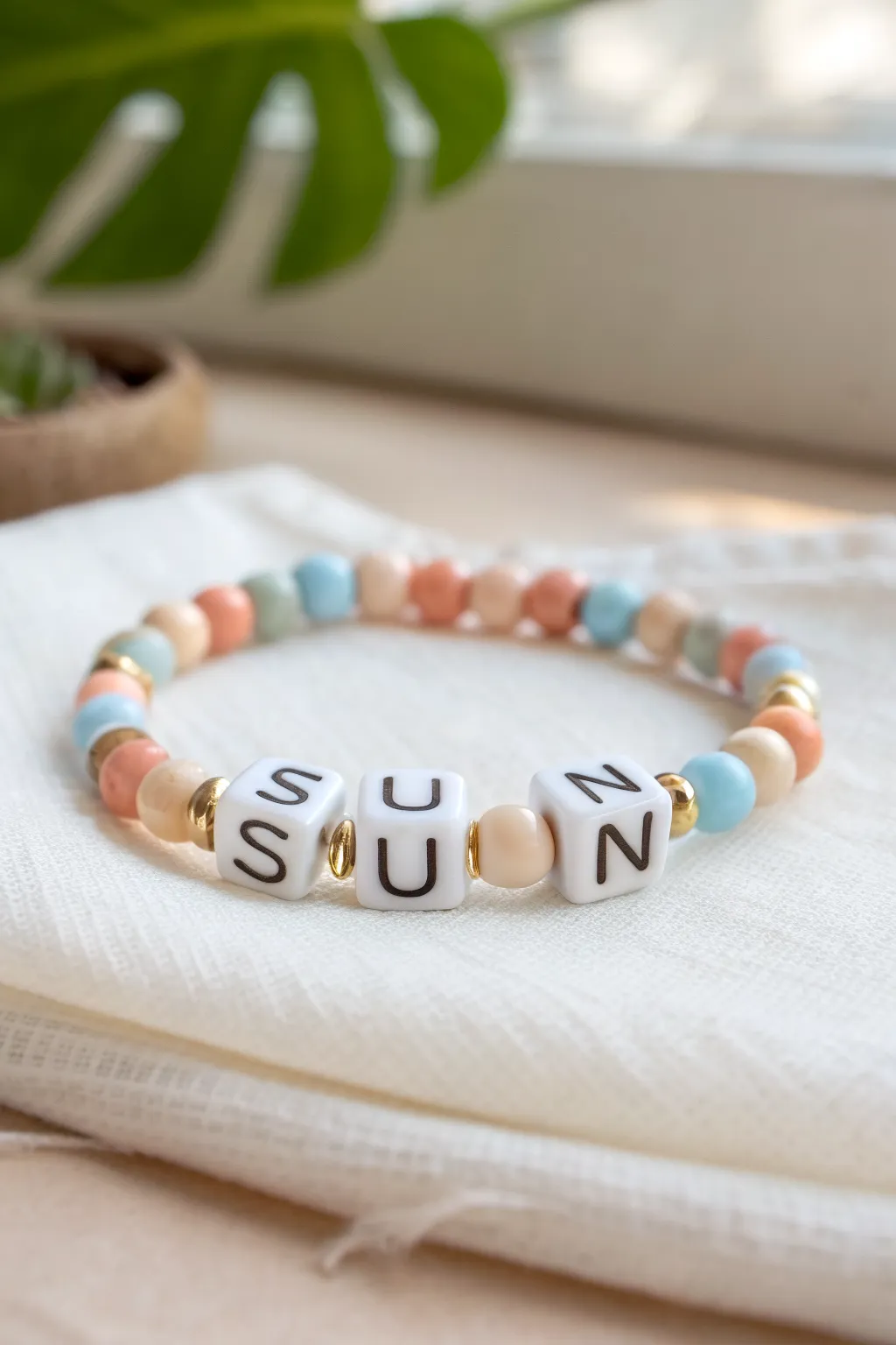 Minimalist personalized summer clay disc bead bracelet with SUN letters and delicate gold spacers