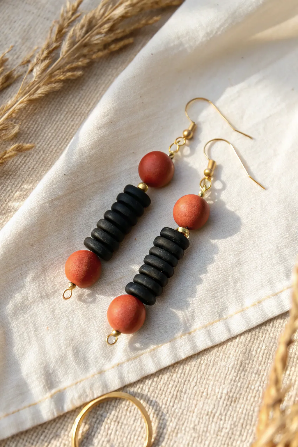 Sleek monochrome heishi earrings with one bold pop bead for an effortless everyday look.