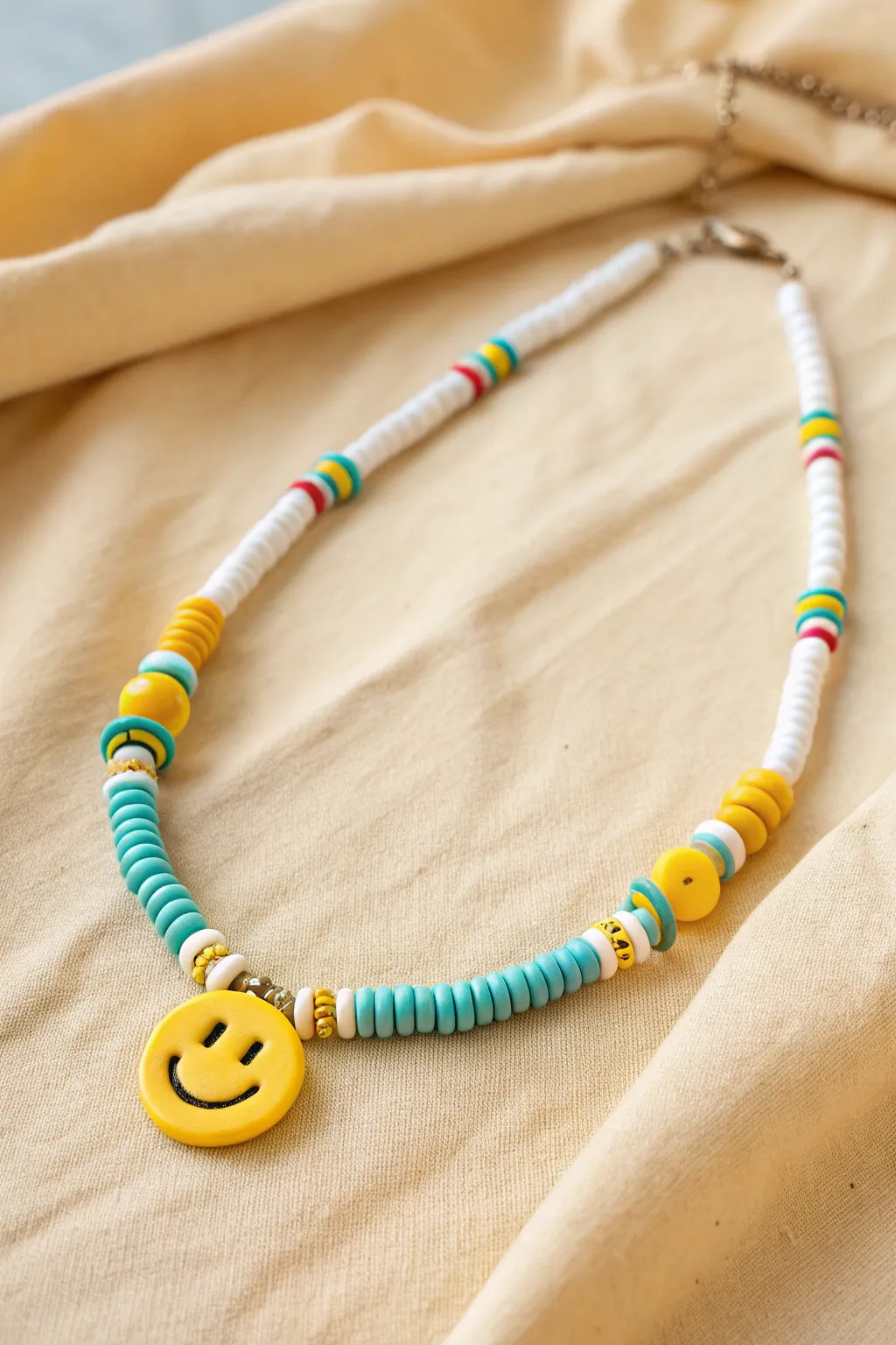 Sunny heishi necklace with a bold smiley bead, perfect for easy summer clay jewelry.