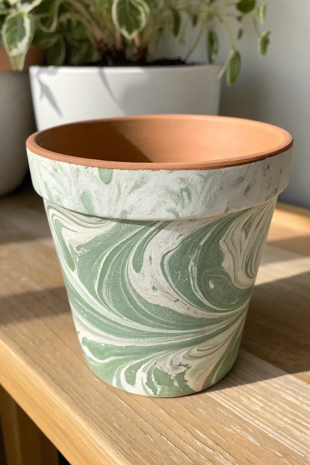 Minimal marbled swirl terracotta pot in sage and white for an easy, chic DIY update