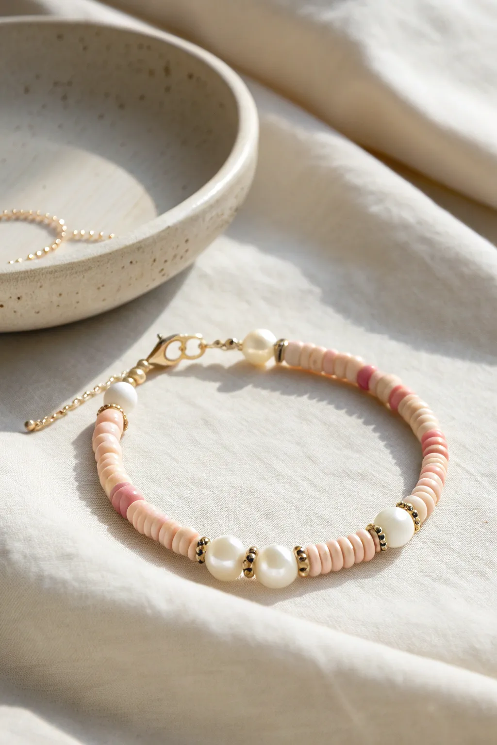 Matte clay heishi beads meet softly glowing pearls for a clean, boho-minimal bracelet.