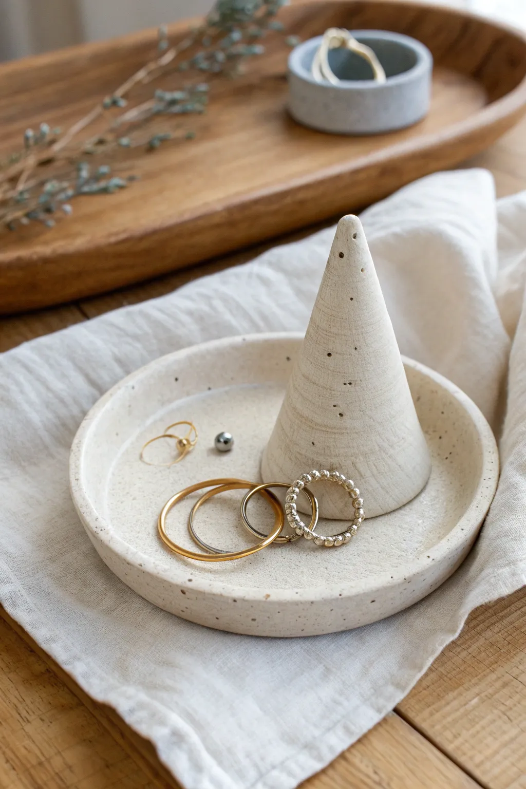 Minimal ring cone dish in speckled clay, made to keep rings stacked and earrings tidy
