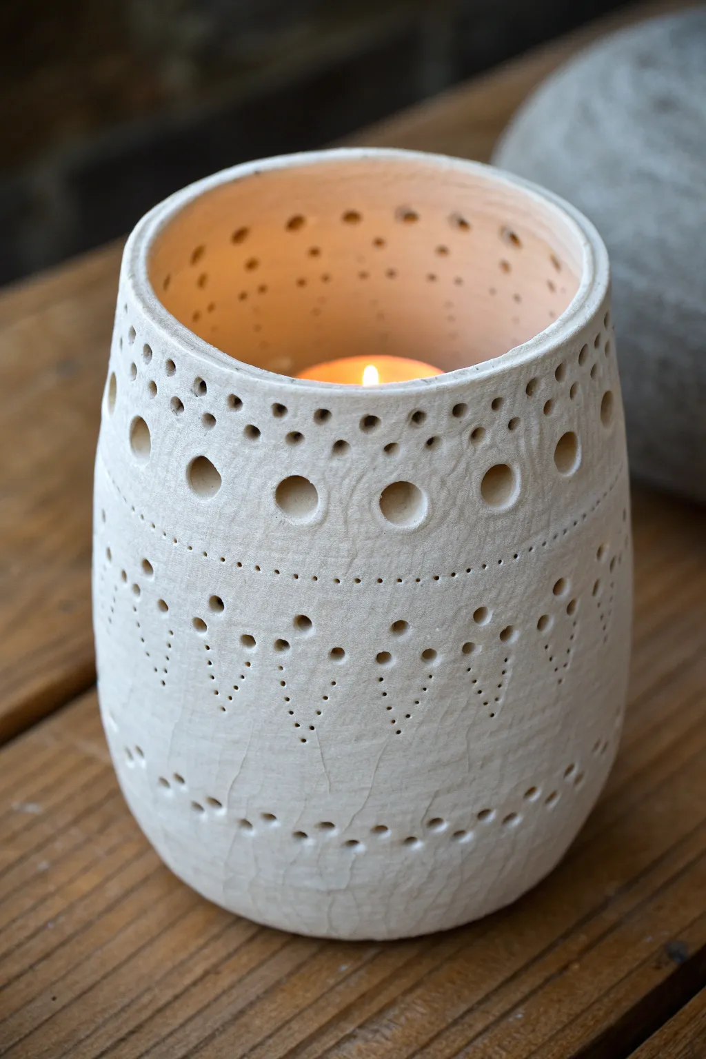 Textured cup lantern with punched holes, softly glowing for cozy minimalist boho nights.