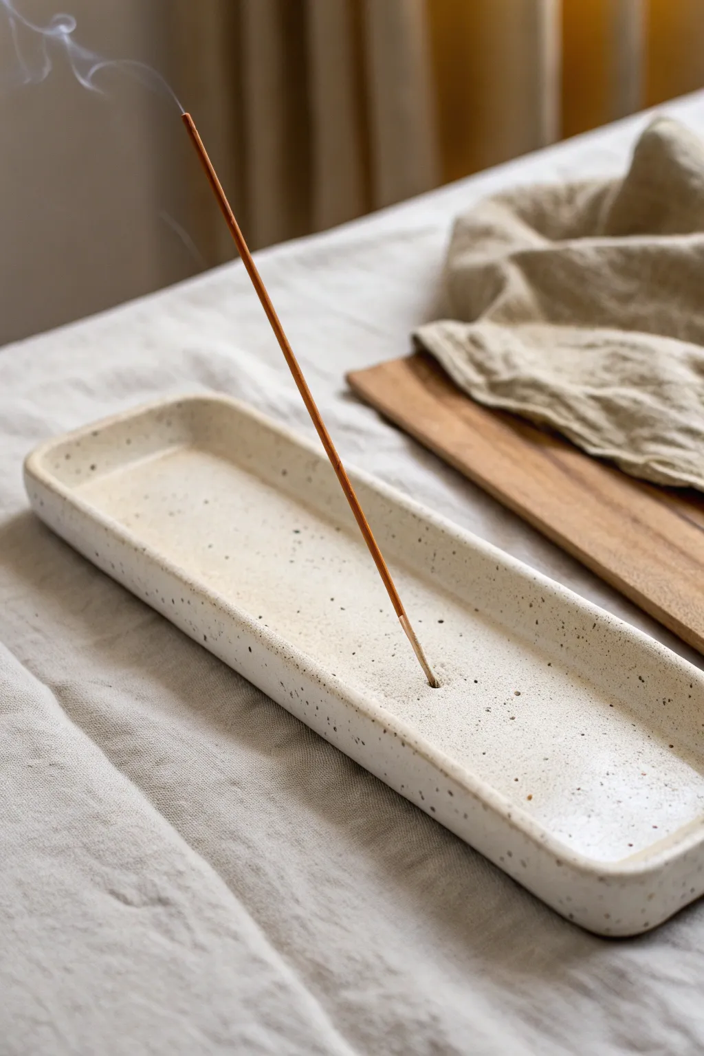 Minimal slab incense holder with raised edges, calm neutral styling and crisp handmade texture.