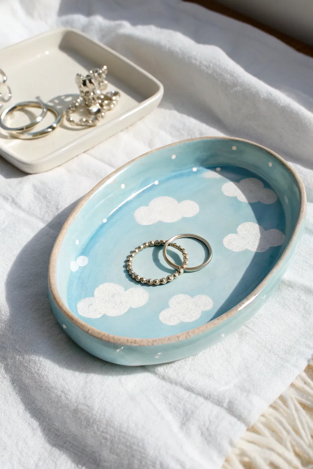 Soft blue cloudy gradient clay tray with glossy finish, styled for airy minimalist jewelry storage
