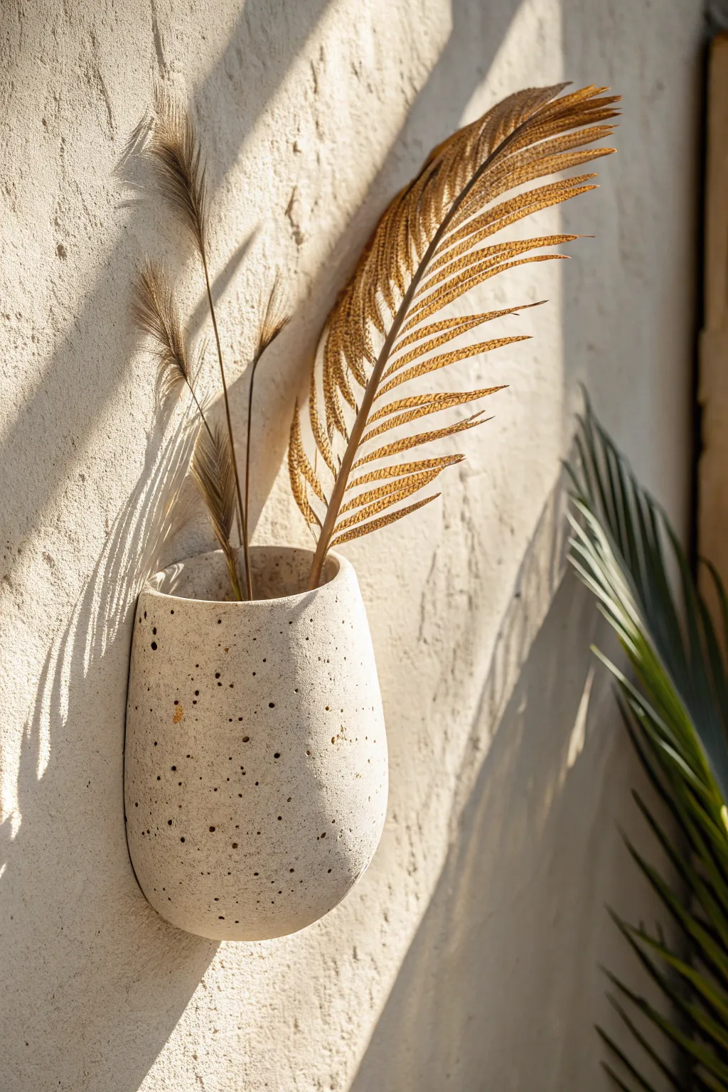 Speckled clay wall pocket with a clear finish, styled with dried palm leaves for soft boho calm.