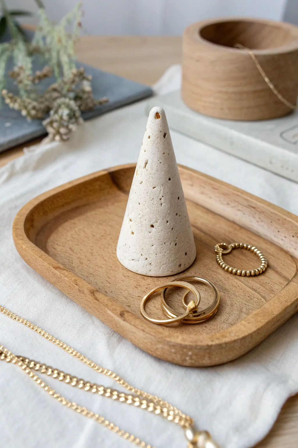 Minimal clay ring cone with a petite peg stand, styled in warm neutrals for a calm boho look