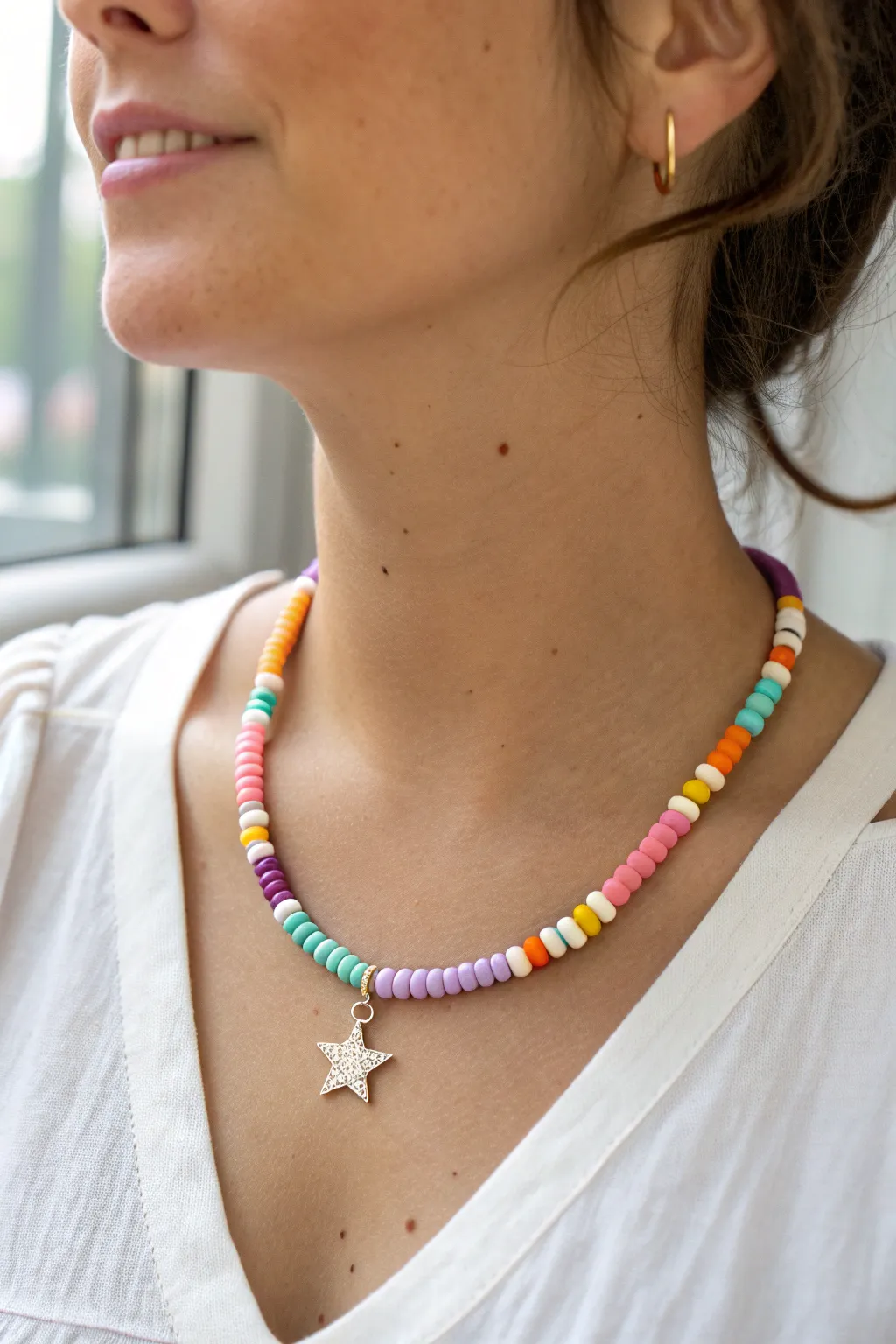 Bold bright heishi choker with a tiny centered star charm for playful everyday clay bead style.
