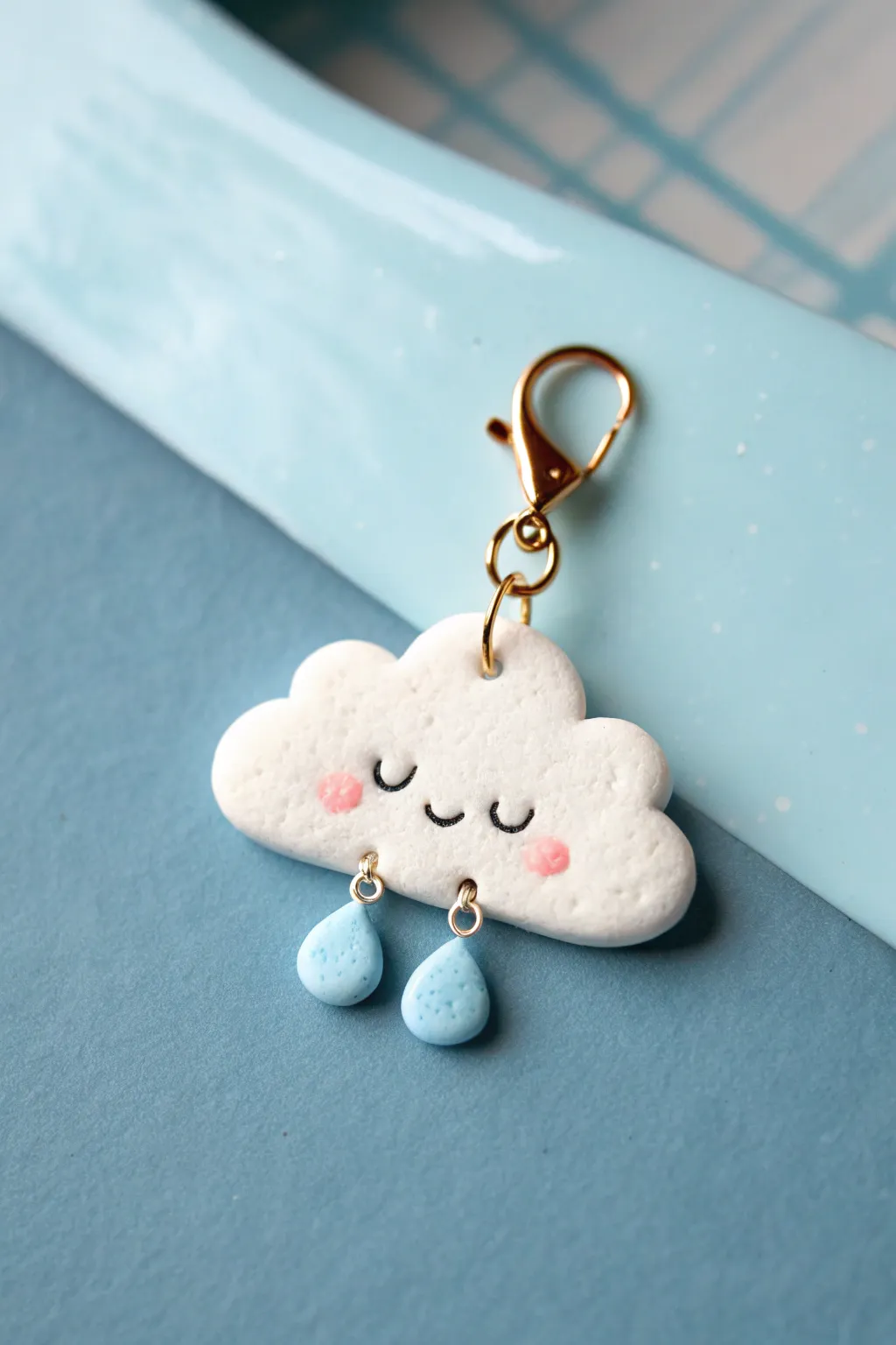 Sweet cloud and raindrop dangle charm in soft sky tones, minimalist and handmade.