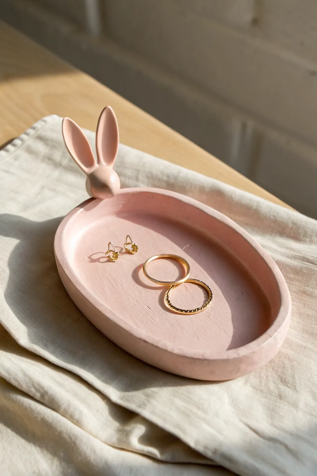 Pastel pink bunny-ear tray that keeps your tiny treasures tidy with soft, sweet charm.