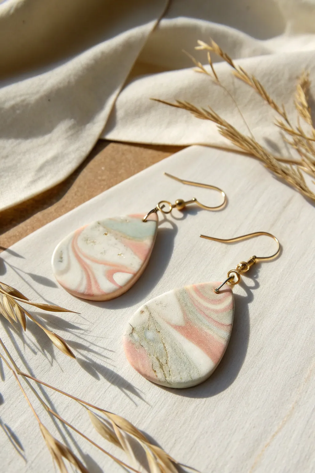 Soft marble swirl teardrop earrings in cream, blush, and sage for a calm minimalist look