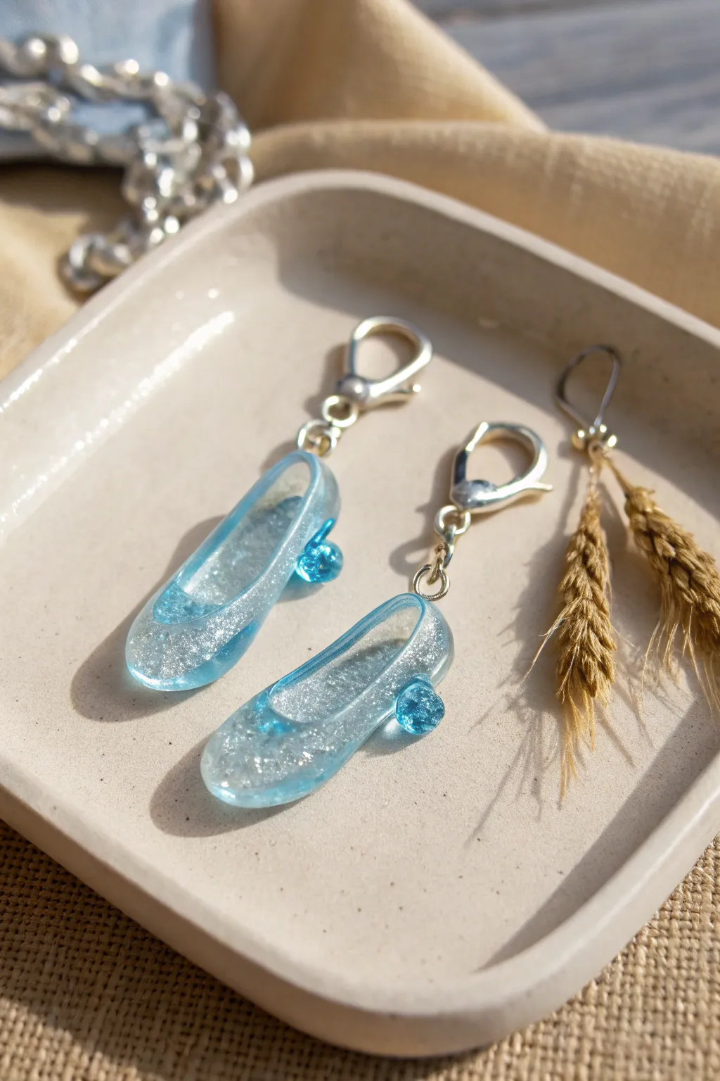 Fairytale glass-slipper charm set in shimmering blue, minimalist styling for dreamy Disney clay inspo