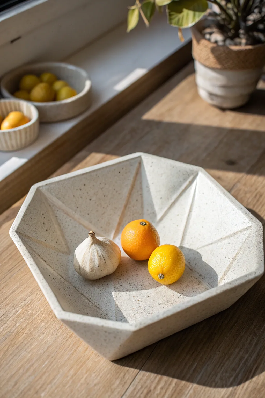 Faceted drape tray with crisp planes, styled with citrus and garlic in soft natural light
