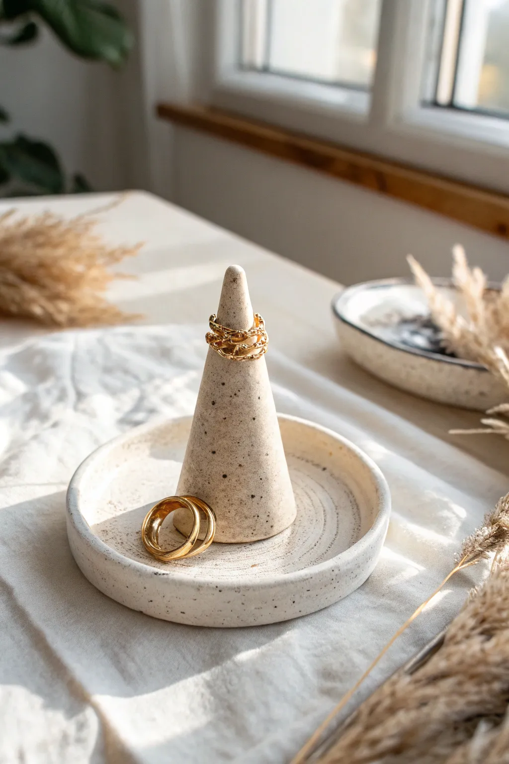Minimal clay ring cone on matching tray, styled with stacked rings for a simple handmade gift