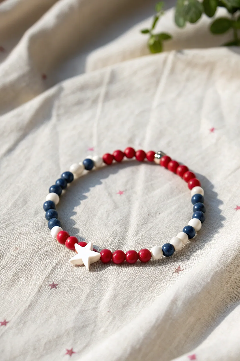 Minimalist clay bead bracelet with a tiny navy star section and classic red-white beads.