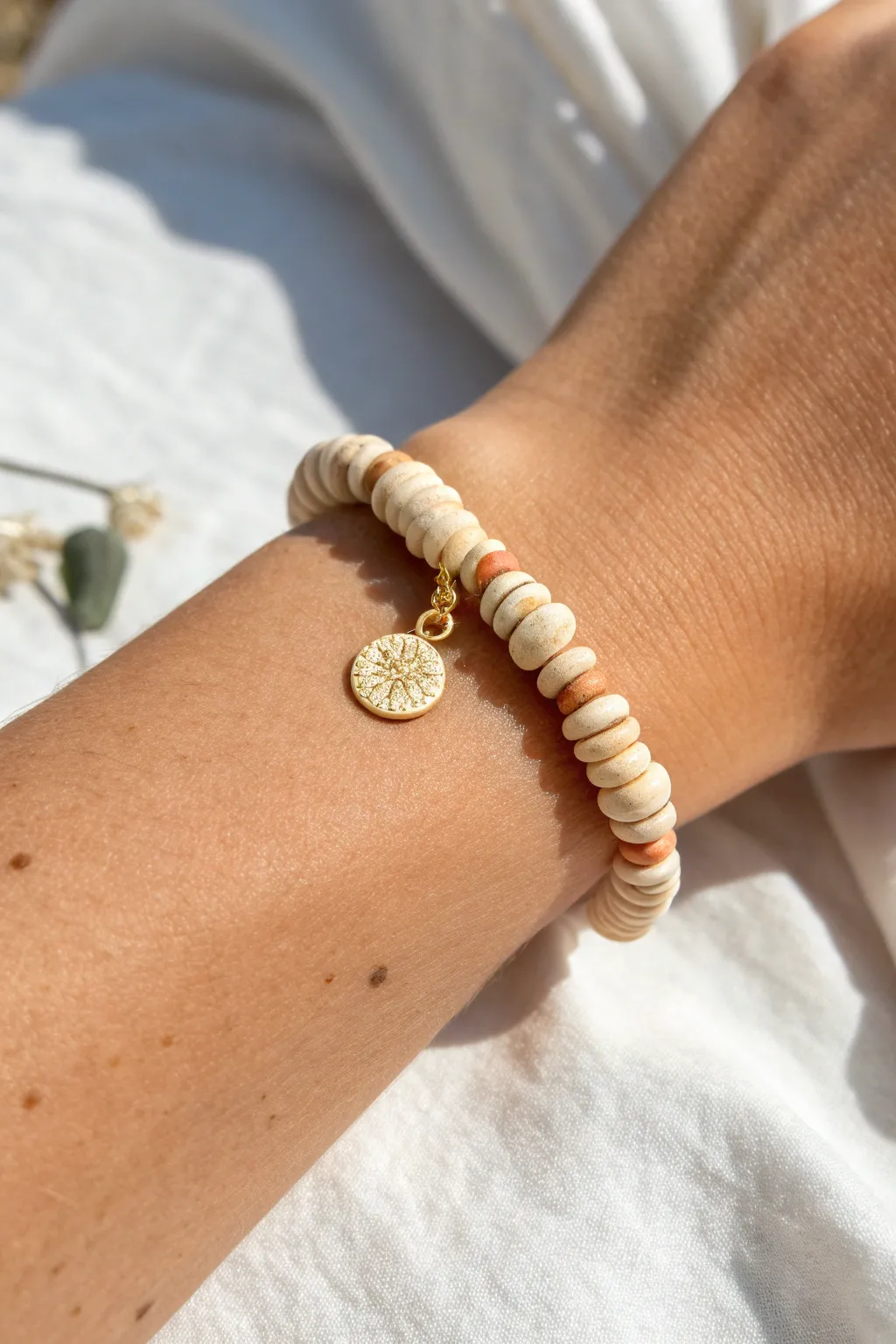 Tiny charm drop bracelet with clay disc bead clusters, simple boho detail and clean Nordic calm.