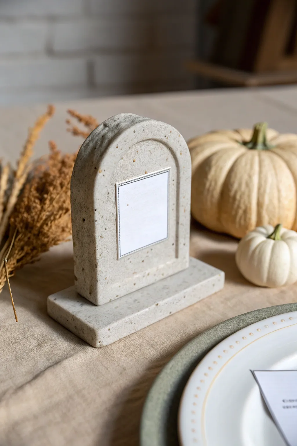 Minimal clay tombstone place card marker in speckled stone gray, perfect for chic Halloween tables