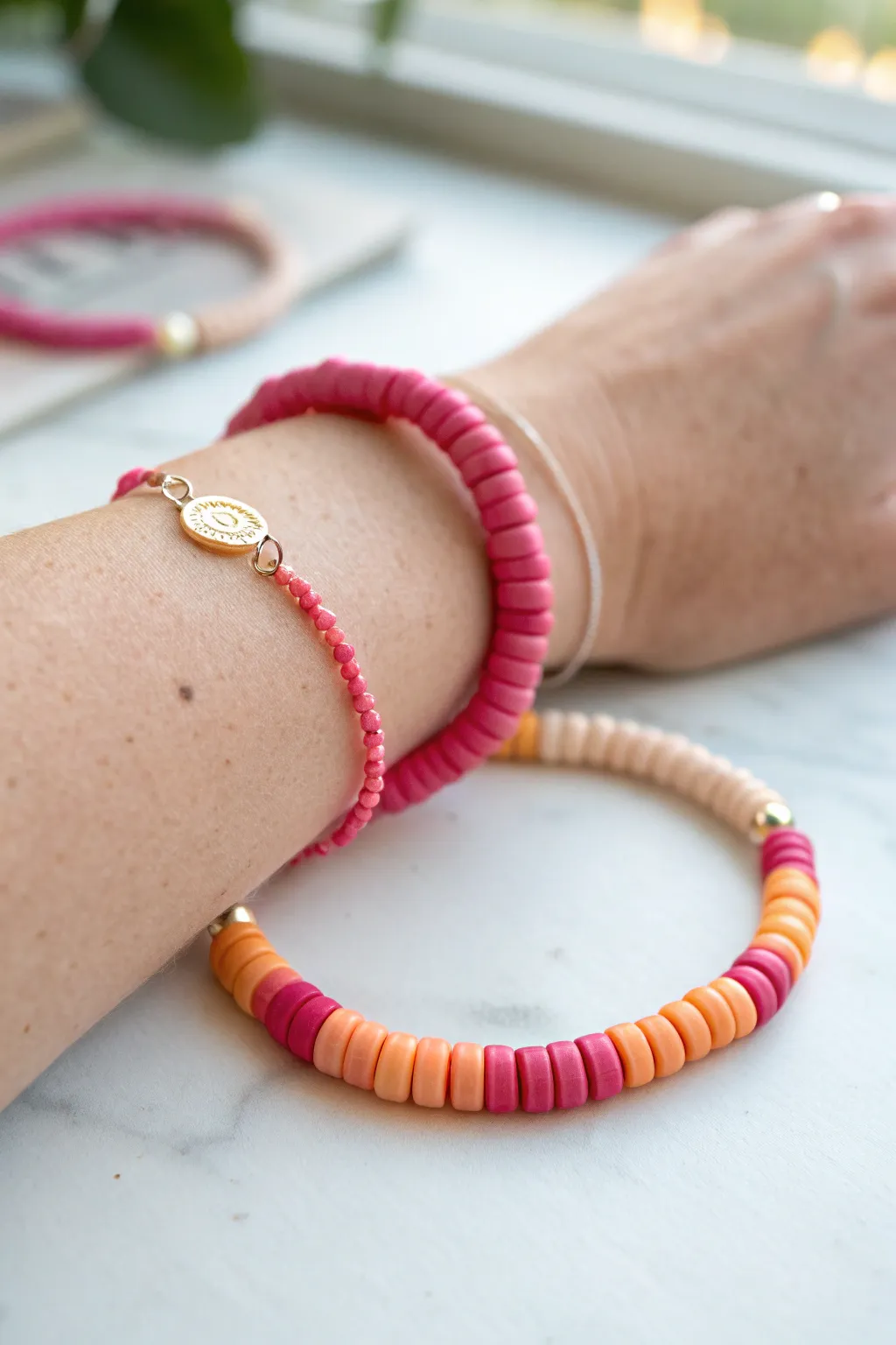 Sunset ombre heishi bead bracelet in soft pastels, a simple kids craft with big wow factor.