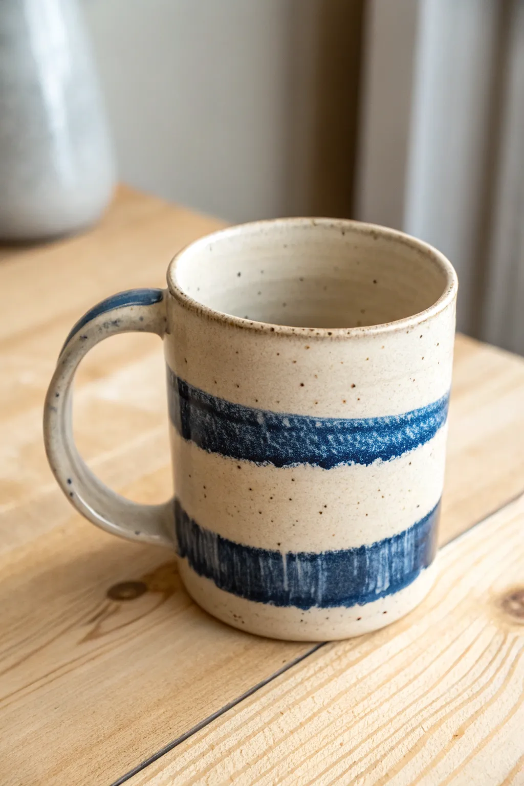 Handmade mug with loose brushstroke glaze bands, Scandinavian minimalism with boho warmth