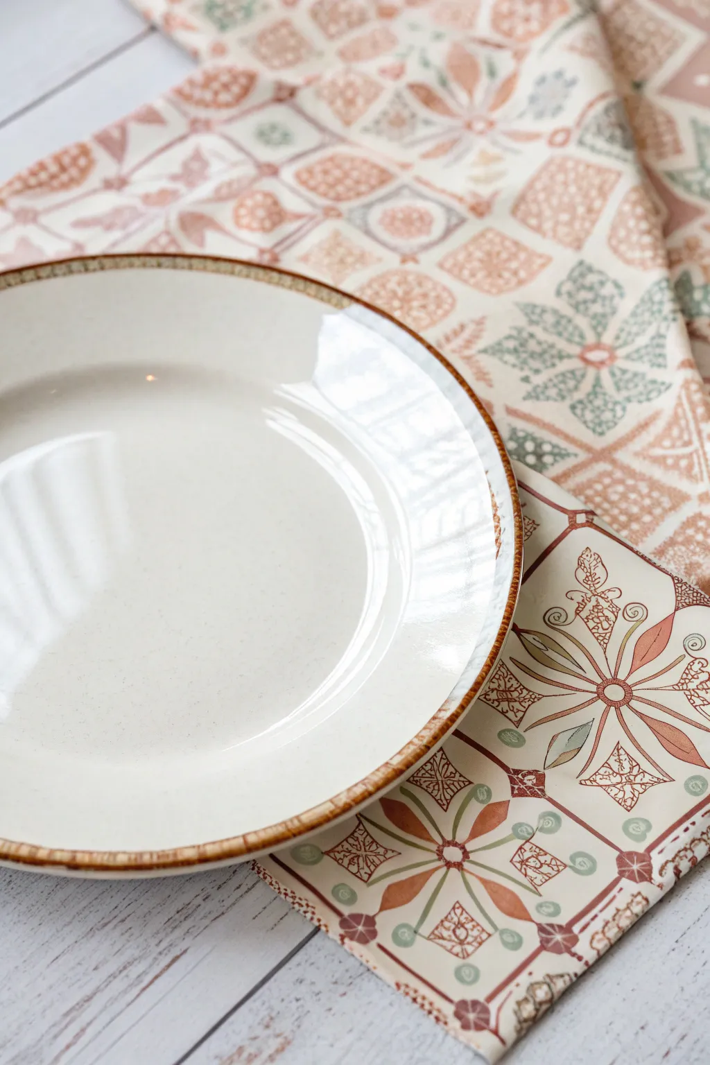 Glossy decoupage plate with boho pattern sealed underneath for chic, simple decor.