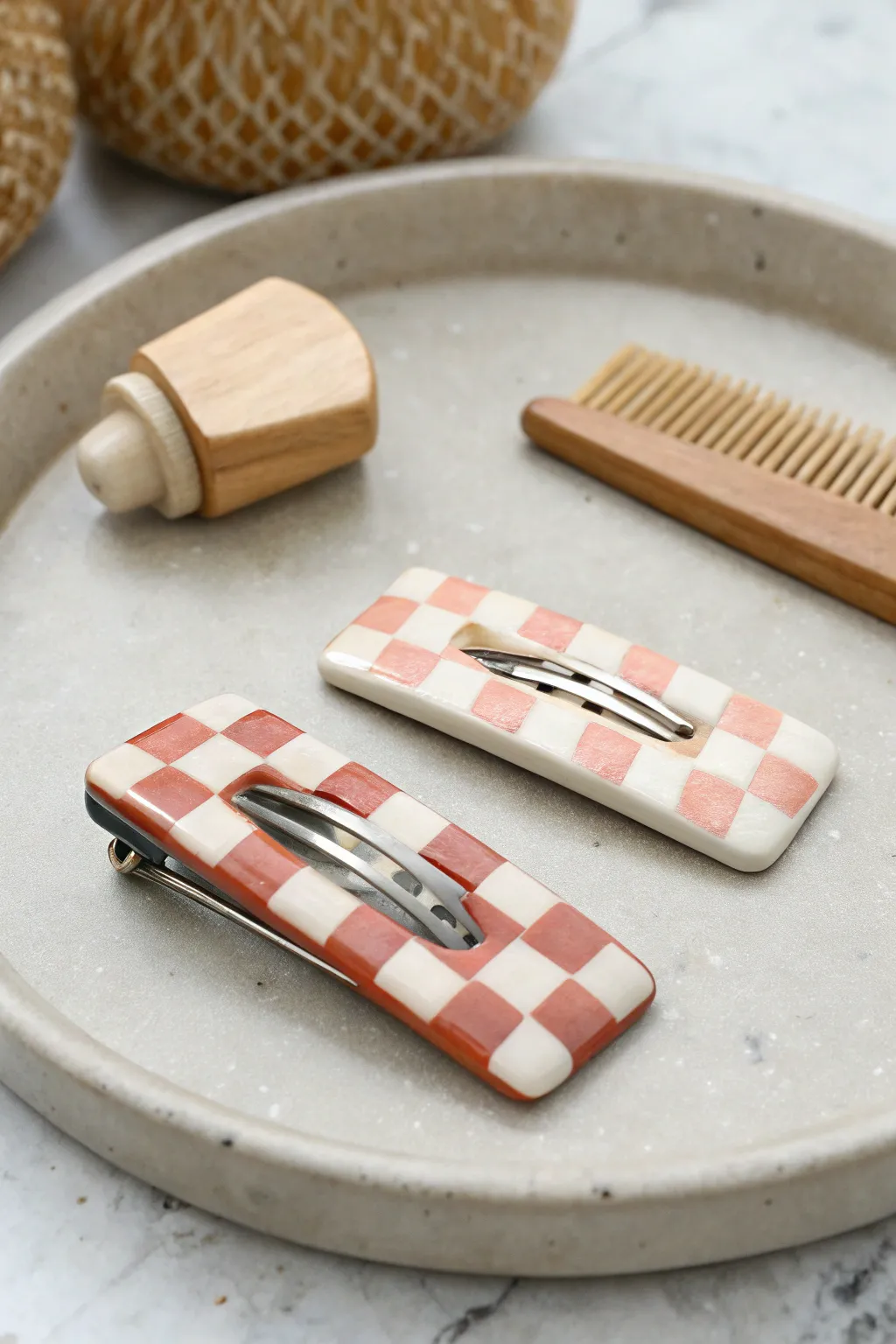Statement polymer clay hair clip with bold slab pattern, styled on a minimal vanity tray