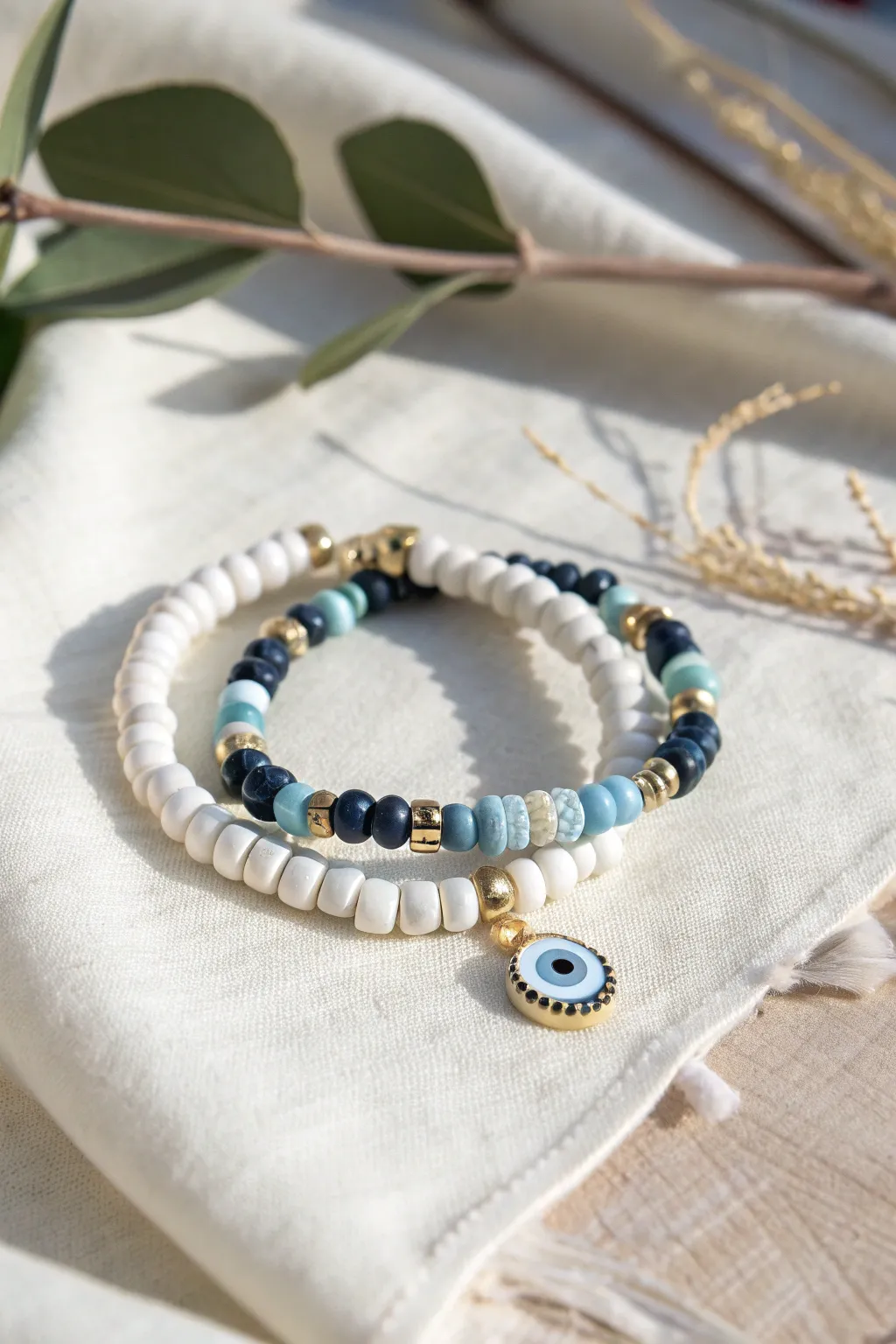 Preppy blue and white clay bead stack with a chic evil eye charm, clean and polished