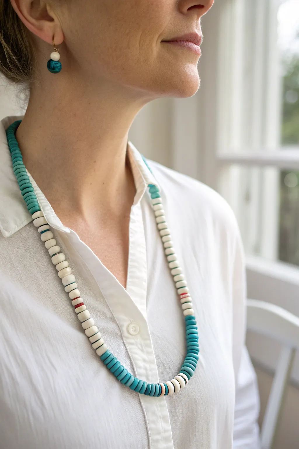 Preppy coastal clay heishi necklace in ocean blues and crisp whites on a linen button-up.