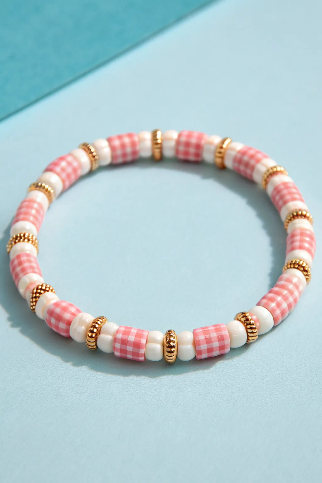 Gingham-inspired heishi mix in blush and white for a neat, preppy bracelet with handmade charm