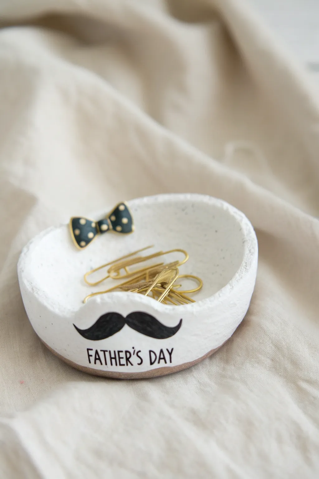 Minimal salt dough mustache dish with paperclips, a sweet handmade Fathers Day gift for dad