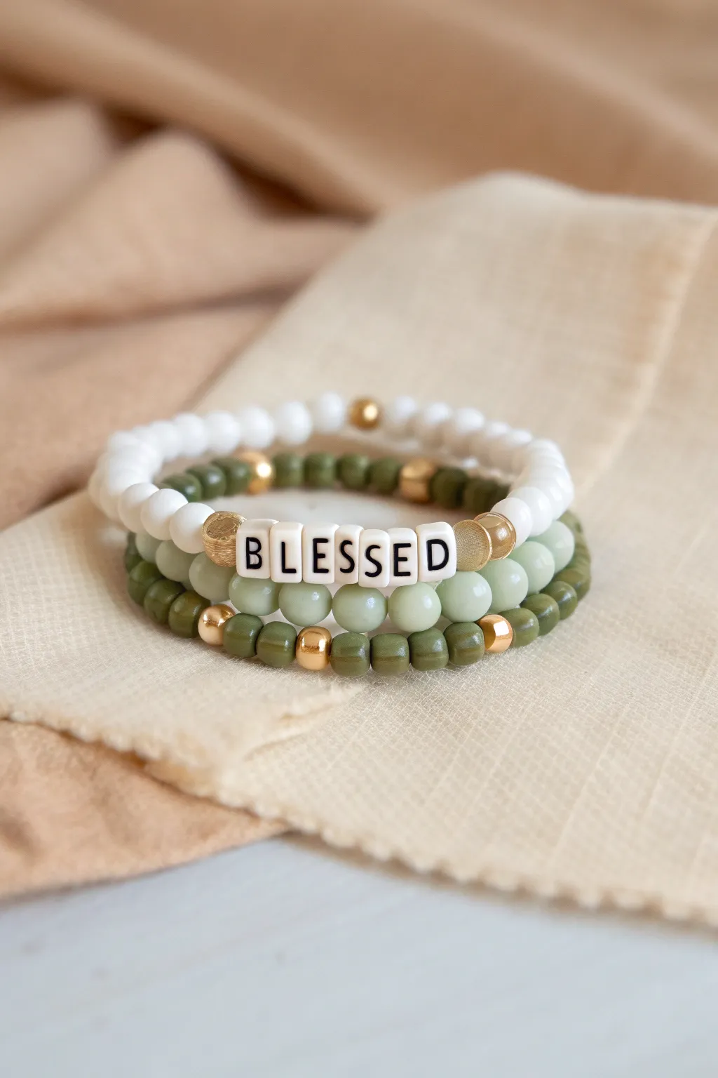 Soft neutral and sage clay bead stack with Blessed letter beads for subtle St Patricks Day style