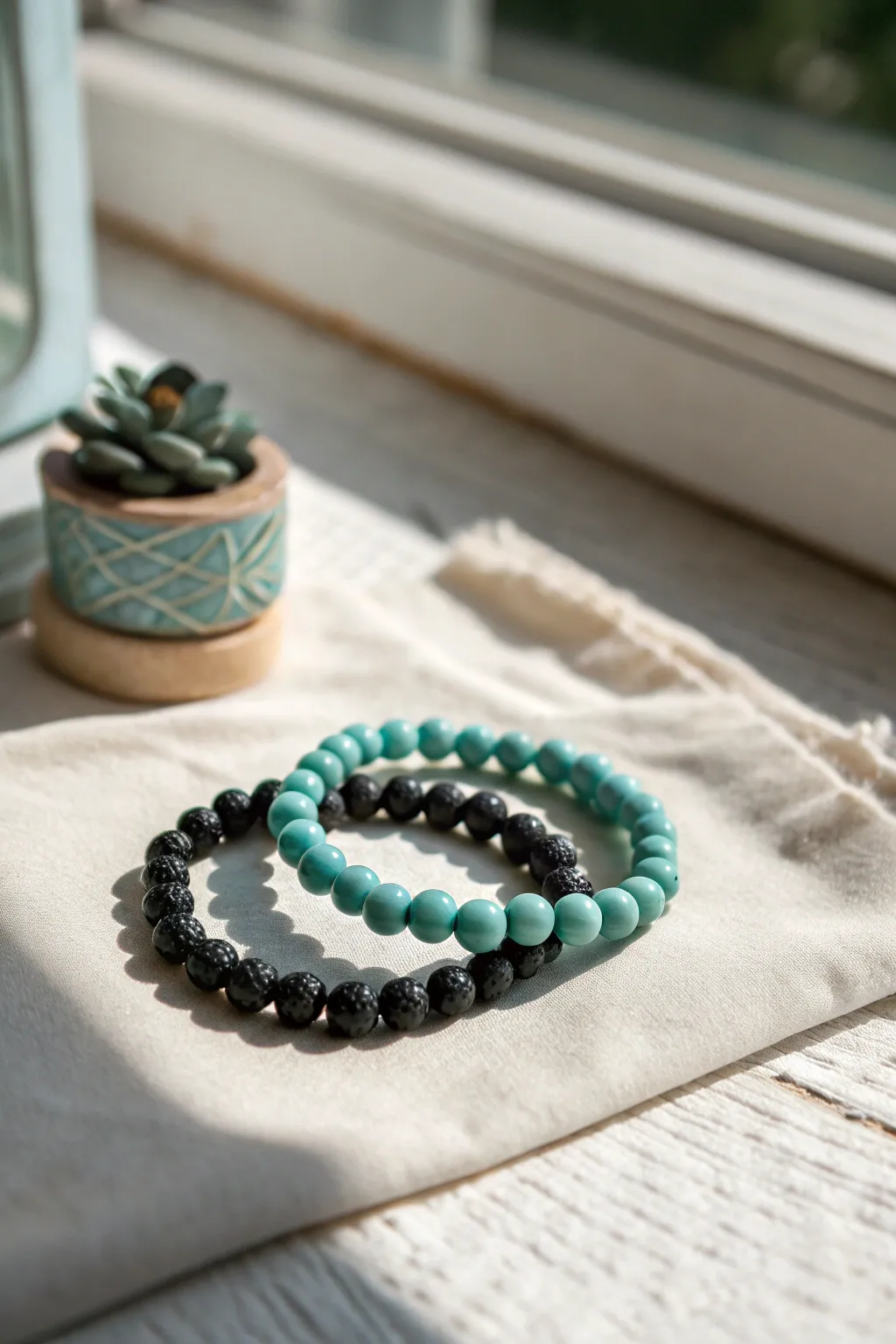 Sporty teal and black clay bead bracelet stack that pops against a clean Scandinavian backdrop