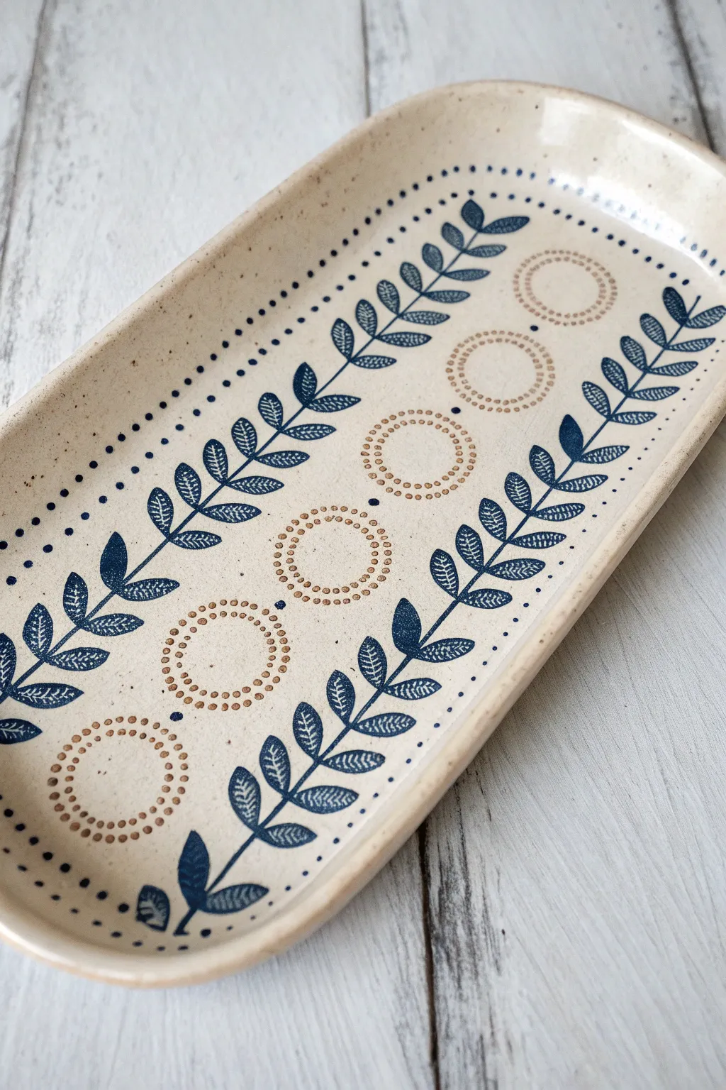 Minimal stamped ceramic tray with underglaze-filled texture, finished under clear glaze glow.