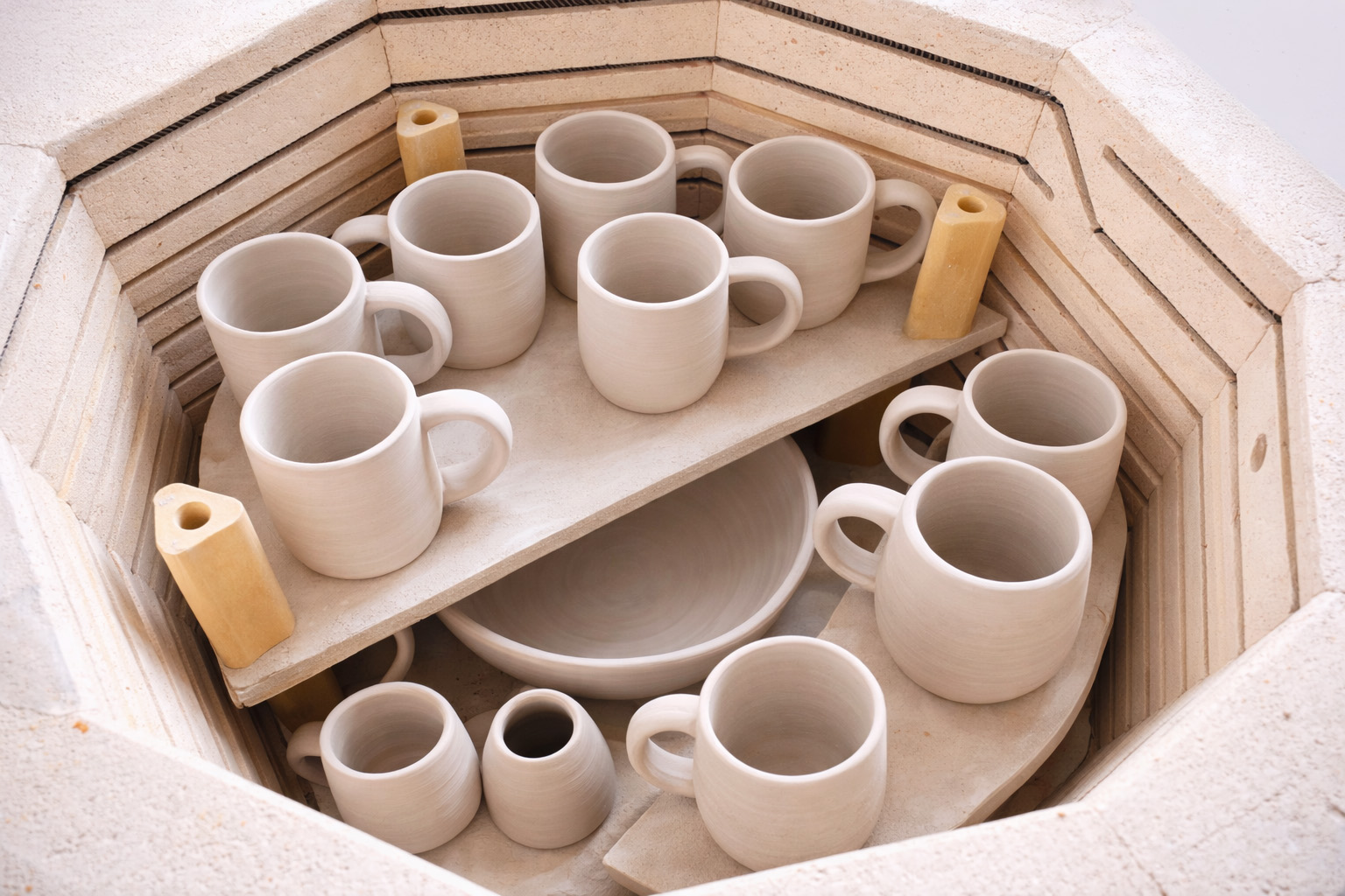 Ceramic mugs in a kiln