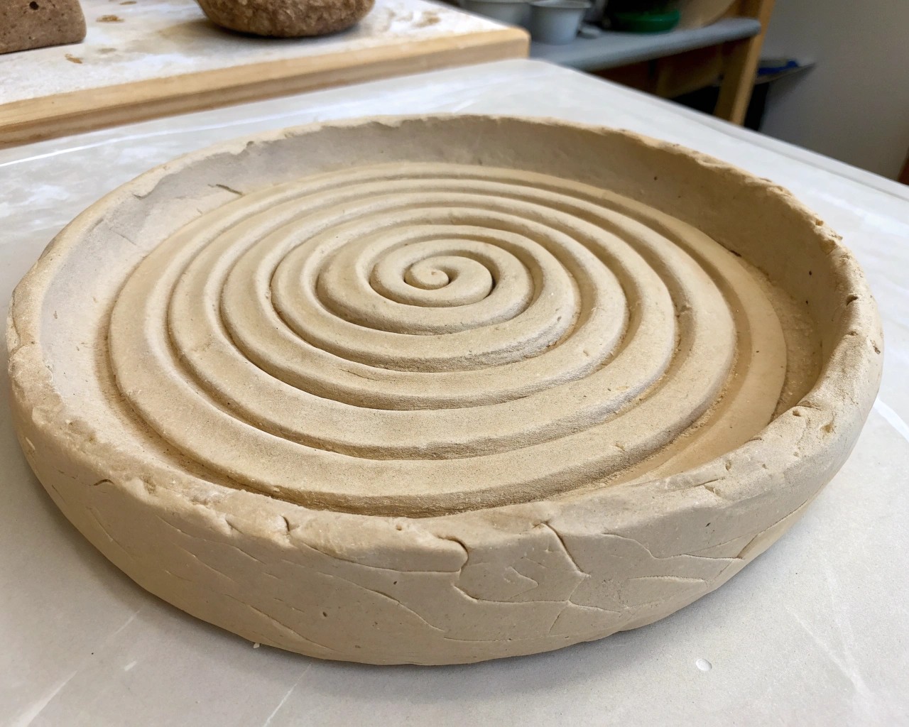 Wedging clay is a crucial step in pottery, removing air bubbles and ensuring a consistent texture for shaping.